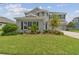 Gray two-story house with landscaping and a large front yard at 6317 Brevada Ln, Apollo Beach, FL 33572