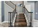 Elegant staircase with dark wood treads and wrought iron railings at 6317 Brevada Ln, Apollo Beach, FL 33572