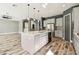 Open-concept kitchen with a large island, stainless steel appliances, and modern pendant lights at 6317 Brevada Ln, Apollo Beach, FL 33572