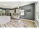 Modern kitchen with gray cabinets, stainless steel appliances, tile backsplash, and wood-look floors at 6317 Brevada Ln, Apollo Beach, FL 33572