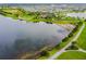 Aerial view of a community lake, walking path, and green spaces at 6317 Brevada Ln, Apollo Beach, FL 33572