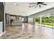 Open living area adjacent to a kitchen, featuring sliding glass doors and natural light at 6317 Brevada Ln, Apollo Beach, FL 33572