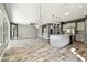 Expansive living room and kitchen area with wood-look tile flooring at 6317 Brevada Ln, Apollo Beach, FL 33572