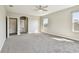 Spacious main bedroom featuring neutral carpet, ceiling fan, and a doorway to the main bathroom at 6317 Brevada Ln, Apollo Beach, FL 33572