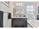 Bathroom with dark brown vanity, granite countertop, and a large mirror at 6317 Brevada Ln, Apollo Beach, FL 33572