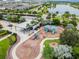 Aerial view of the community playground with colorful play structures, shade, benches and lush landscaping at 6317 Brevada Ln, Apollo Beach, FL 33572