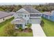 Two-story house with gray siding, gray roof and a landscaped yard at 6317 Brevada Ln, Apollo Beach, FL 33572