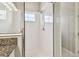 Modern bathroom shower with pristine white tiles, a rainfall showerhead, and a convenient window at 6317 Brevada Ln, Apollo Beach, FL 33572