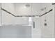 Modern bathroom shower boasts stylish tile work, dual shower heads, and a sleek glass door at 6317 Brevada Ln, Apollo Beach, FL 33572