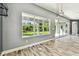 Bright sun room with large windows, wood-look tile flooring, and a view of the backyard at 6317 Brevada Ln, Apollo Beach, FL 33572