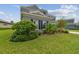 Two-story house with gray siding, landscaping, and a neatly manicured lawn at 6317 Brevada Ln, Apollo Beach, FL 33572