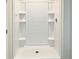 Clean shower with built-in shelving and white tile surround at 7231 Somerset Pond Dr, Ruskin, FL 33573