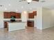 Kitchen with island, stainless steel appliances, and dark wood cabinets at 7231 Somerset Pond Dr, Ruskin, FL 33573