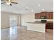 Kitchen with island, stainless steel appliances, and dark wood cabinets at 7231 Somerset Pond Dr, Ruskin, FL 33573