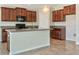 Kitchen with island, stainless steel appliances, and dark wood cabinets at 7231 Somerset Pond Dr, Ruskin, FL 33573