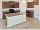 Kitchen with island, stainless steel appliances, and dark wood cabinets at 7231 Somerset Pond Dr, Ruskin, FL 33573