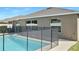 Rear view of house showing pool and fenced backyard at 7231 Somerset Pond Dr, Ruskin, FL 33573