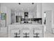 Modern white kitchen with island, breakfast bar, and stainless steel appliances at 777 N Ashley Dr # 2613, Tampa, FL 33602