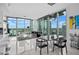 Bright open concept dining area featuring floor to ceiling windows, sleek black dining set, and city views at 777 N Ashley Dr # 2613, Tampa, FL 33602