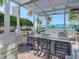 Outdoor kitchen with grill, seating, and pergola at 777 N Ashley Dr # 2613, Tampa, FL 33602