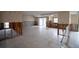 Large living room undergoing renovation, showcasing new tile flooring and exposed framing at 9830 San Sierra Way, Port Richey, FL 34668