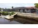 Backyard view showing a canal-front home, pool, and private dock at 9830 San Sierra Way, Port Richey, FL 34668