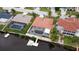 Aerial view showing canal-front home, pool, dock, and boat lifts at 9830 San Sierra Way, Port Richey, FL 34668