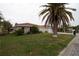 House exterior with a stone facade and palm trees at 9830 San Sierra Way, Port Richey, FL 34668