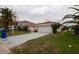 House exterior with a two-car garage and driveway at 9830 San Sierra Way, Port Richey, FL 34668