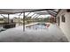 Screened pool and patio area with canal views at 9830 San Sierra Way, Port Richey, FL 34668