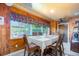 Dining area with wood-paneled walls and a table for six at 10036 63Rd N Ave # 23, St Petersburg, FL 33708