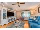Living room with blue couch, white entertainment center, and wood floors at 10036 63Rd N Ave # 23, St Petersburg, FL 33708