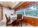 Dining area with wood-paneled walls and a table for six at 10036 63Rd N Ave # 23, St Petersburg, FL 33708