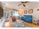 Living room with blue couch and view into kitchen area at 10036 63Rd N Ave # 23, St Petersburg, FL 33708