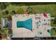 Aerial view of a community pool with many people enjoying a sunny day at 10036 63Rd N Ave # 23, St Petersburg, FL 33708