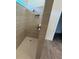 Large walk-in shower with neutral tile and a built-in niche at 10260 Beach Dune Dr, Englewood, FL 34223