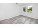 Simple bedroom with gray flooring and two large windows at 3402 E 28Th Ave # 1, Tampa, FL 33605