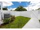 Fenced backyard featuring a small lawn and air conditioning unit at 3402 E 28Th Ave # 1, Tampa, FL 33605