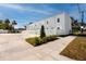 Modern townhome exterior featuring white facade, grass lawn and parking lot at 3402 E 28Th Ave # 1, Tampa, FL 33605