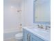 Stylish bathroom with white subway tile, blue vanity, and marble countertop at 3731 Tea Leaf Aly, Land O Lakes, FL 34638