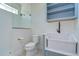 Bathroom with walk-in shower, toilet, and farmhouse sink with open shelving at 3731 Tea Leaf Aly, Land O Lakes, FL 34638