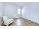 Spacious bedroom with hardwood floors and a comfortable armchair at 3731 Tea Leaf Aly, Land O Lakes, FL 34638