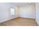 Bright bedroom with hardwood floors and a window with plantation shutters at 3731 Tea Leaf Aly, Land O Lakes, FL 34638