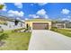 Attached two-car garage with a long driveway at 3731 Tea Leaf Aly, Land O Lakes, FL 34638
