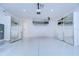 Bright garage with overhead storage and mirrored walls at 3731 Tea Leaf Aly, Land O Lakes, FL 34638