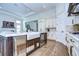 Island kitchen with farmhouse sink and wine cooler at 3731 Tea Leaf Aly, Land O Lakes, FL 34638