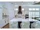 Open concept kitchen with white cabinets and a large island at 3731 Tea Leaf Aly, Land O Lakes, FL 34638