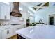 Kitchen with white cabinets, an island, and a wood beam ceiling at 3731 Tea Leaf Aly, Land O Lakes, FL 34638