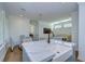 Modern kitchen features a farmhouse sink, white cabinets, and a blue island at 3731 Tea Leaf Aly, Land O Lakes, FL 34638