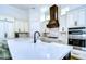 Spacious kitchen with white cabinets, quartz countertops and stainless steel appliances at 3731 Tea Leaf Aly, Land O Lakes, FL 34638